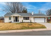 Charming home with a well-manicured lawn, dark trim and modern front door enhancing the curb appeal at 3020 S Leyden St, Denver, CO 80222