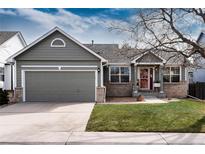 Charming home features a well-manicured lawn, attached two-car garage and beautiful curb appeal at 11650 Columbine St, Thornton, CO 80233