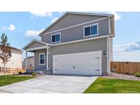 Charming two-story home with attached two car garage and concrete driveway at 7306 Arkansas St, Frederick, CO 80530