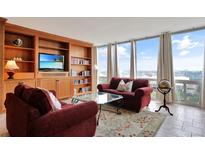 Bright living room featuring large windows, custom built-ins, and comfortable seating, perfect for relaxation with a view at 3100 E Cherry Creek South Dr # 1507, Denver, CO 80209