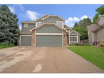Charming two-story home with stone accents, a large driveway, and an attached two-car garage at 3237 W 113Th Ave, Westminster, CO 80031