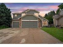 Charming two-story home with stone accents, a three-car garage, mature trees, and beautiful landscaping at 3237 W 113Th Ave, Westminster, CO 80031
