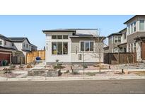 Modern home exterior featuring unique architectural details and a professionally landscaped front yard with rock features at 6353 N Fulton St, Denver, CO 80238