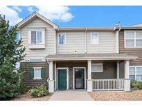 Inviting exterior of a two-story townhome with a covered porch at 14700 E 104Th Ave # 1701, Commerce City, CO 80022