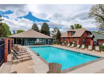 Community pool with lounge chairs and well-maintained grounds, perfect for relaxation and recreation at 3518 S Depew St # 102, Lakewood, CO 80235