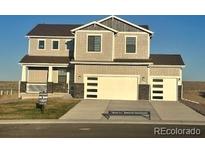 Charming two-story home featuring a two-car garage and covered front porch at 42972 Colonial Trl, Elizabeth, CO 80107