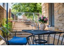 Inviting patio with outdoor dining set, offering a relaxed space for enjoying fresh air and al fresco meals at 1140 Columbine St # 106, Denver, CO 80206