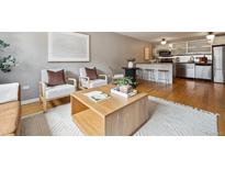 Inviting living room featuring hardwood floors, stylish seating, and a bright, open layout at 75 N Emerson St # 104, Denver, CO 80218