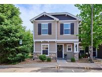 Charming two-story home with a welcoming front porch, lovely landscaping and stone accents at 9066 Apache Plume Dr # E, Parker, CO 80134