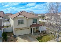 Inviting two-story home with a tile roof, covered front porch and attached two car garage at 5559 Gibraltar St, Denver, CO 80249
