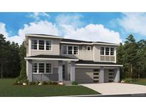 New construction modern home featuring a two-car garage, with gray and beige siding and professional landscaping at 8601 Yellowcress St, Littleton, CO 80125