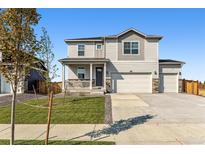 Charming two-story home with a welcoming front porch and a well-manicured lawn at 4635 Cattle Cross Trl, Castle Rock, CO 80104