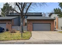 Charming brick front townhome with attached garage and mature trees in a well-maintained community at 2609 S Quebec S St # 20, Denver, CO 80231