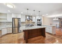 Spacious kitchen featuring stainless steel appliances, granite countertops, and a central island at 2609 S Quebec S St # 20, Denver, CO 80231