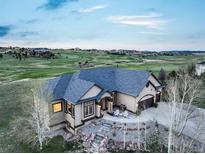 Stunning aerial view of the home overlooking the golf course, offering serene surroundings at 1236 Castlecombe Ln, Monument, CO 80132
