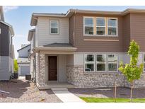 Charming two-story home featuring stone accents and a well-manicured front yard for great curb appeal at 1415 Great Western Dr, Longmont, CO 80501