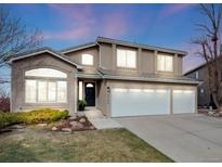 Charming two-story home with a three-car garage, well-maintained lawn, and beautiful landscaping at 6749 Shannon Trl, Highlands Ranch, CO 80130