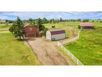 Wide ranch property showcasing multiple outbuildings and perimeter fencing at 35675 Cheyenne Trl, Elizabeth, CO 80107