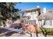 Inviting two-story home showcasing a private yard and exterior brickwork at 5317 W Iliff Dr # 103, Lakewood, CO 80227