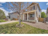 Charming two-story home with a well-maintained lawn, front porch, and welcoming curb appeal at 4037 S Odessa Cir, Aurora, CO 80013
