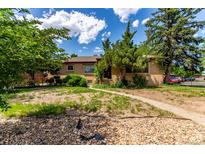 Charming ranch-style home with a well-maintained front yard and mature trees at 10841 Montview Blvd, Aurora, CO 80010