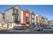 Modern townhomes with colorful exteriors, featuring private balconies and well-maintained streetscapes at 1051 Chase St, Lakewood, CO 80214