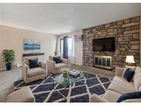 Cozy living room with a stone fireplace and modern decor at 381 S Ames St # G101, Lakewood, CO 80226