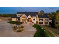 Stunning two-story home with stone accents and a well-manicured front yard at 5790 Fox Run Ct, Parker, CO 80134