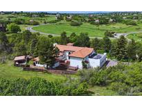 Expansive property with a beautiful Spanish-style home and a sprawling green landscape at 326 E Oak Hills Dr, Castle Rock, CO 80108