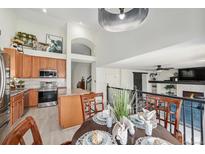 Eat-in kitchen featuring stainless steel appliances and a granite-topped island with seating at 15776 E 107Th Way, Commerce City, CO 80022