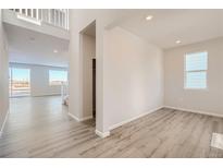Bright living room featuring sleek floors and a large window with scenic views at 14139 Bunny Hop Ln, Parker, CO 80134