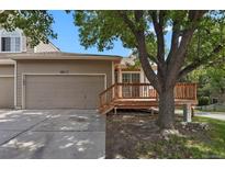Charming exterior of home featuring a two-car garage and a cozy wooden deck with stairs at 4883 W 68Th Ave # 3, Westminster, CO 80030