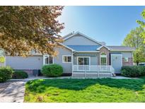 Charming home with a well-maintained lawn, lovely porch, and mature trees at 9025 W 79Th Way # D, Arvada, CO 80005