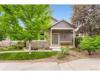 Charming single-Gathering home with stone accents, a well-manicured lawn, and a cozy front porch at 2716 Dundee Pl, Erie, CO 80516