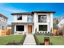 Contemporary two-story home featuring a modern design, manicured lawn, and inviting walkway at 1518 S Columbine St, Denver, CO 80210