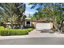Charming brick home featuring a well-manicured lawn and a two-car garage at 16563 E Kansas Pl, Aurora, CO 80017