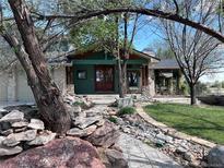 Charming exterior featuring stone accents, unique architecture, and mature trees in a peaceful setting at 11510 Lewistown St, Commerce City, CO 80022