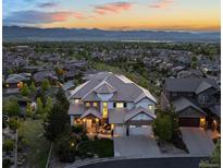 Expansive home featuring mountain views, neutral colors, and professional landscaping at 10525 Sunshower Pl, Highlands Ranch, CO 80126