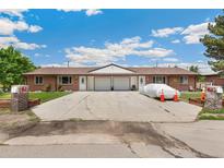 Charming duplex with brick exterior, driveway, garage, and well-maintained lawns, perfect for comfortable living at 5645 W 5Th Ave # 5645 & 5655, Lakewood, CO 80226