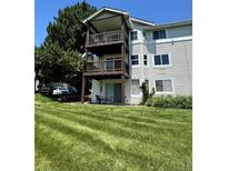 Exterior of a multi-level home with balconies overlooking a well-maintained lawn at 17361 E Mansfield Ave # 521R, Aurora, CO 80013