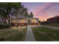 Charming single-story home with brick accents and a modern front door at dusk at 9220 Yucca Way, Thornton, CO 80229