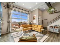 Sun-filled living room featuring modern décor, large windows, and access to the outdoor patio at 10105 Morrison Rd, Lakewood, CO 80227