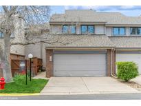 Charming townhome featuring a two-car garage and neutral color scheme on a sunny day at 155 Xenon St # 33, Denver, CO 80228