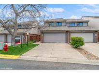Well-maintained townhome featuring attached garage and neutral exterior paint at 155 Xenon St # 33, Lakewood, CO 80228