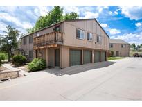 Charming townhome featuring a private balcony and garage spaces in a well-maintained community at 7700 W Glasgow Pl # 24C, Littleton, CO 80128