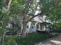 Charming home with a well-maintained yard and mature trees, offering shade and curb appeal at 3098 W 39Th Ave, Denver, CO 80211