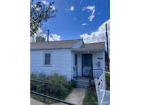 Exterior shot of single story home with white siding and small front yard at 3816 W Dakota Ave, Denver, CO 80219