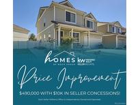 Exterior home shot shows the front of the home, lawn and roof with a price reduction notice at 20530 Randolph Pl, Denver, CO 80249