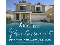 Two-story home with a garage, a motorcycle parked outside, and a small seating area on the front porch at 20530 Randolph Pl, Denver, CO 80249