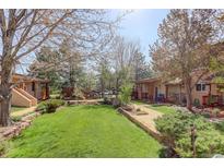 Exterior of building with trees and green lawn at 1460 Quince Ave # 102, Boulder, CO 80304